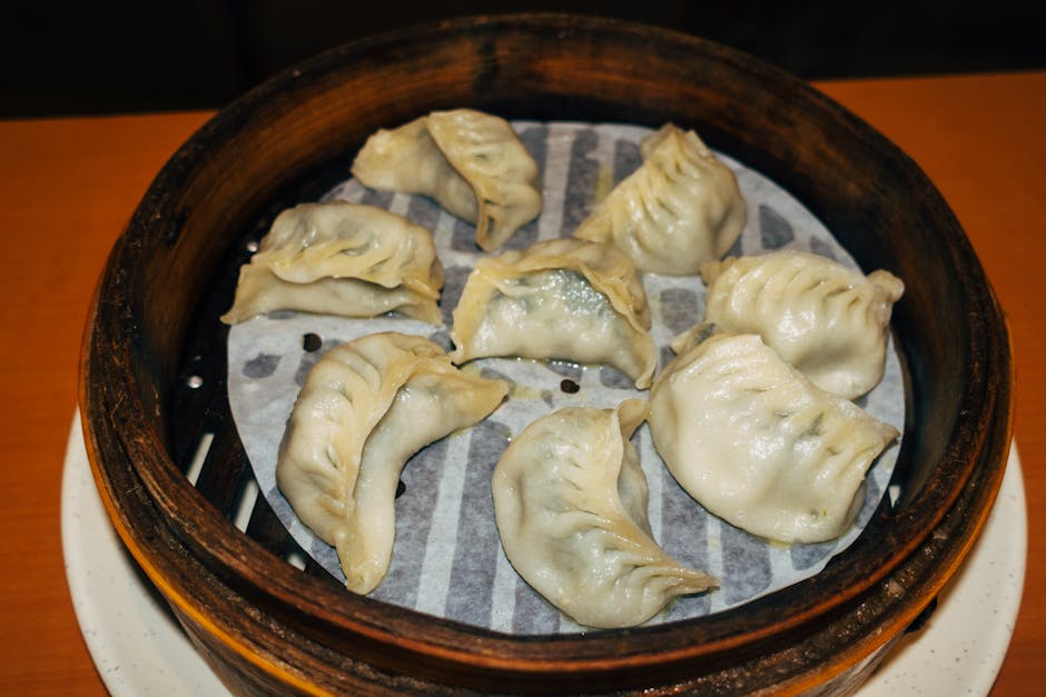 Close-up of traditional steamed dumplings in a bamboo basket, perfect for lunch or dinner